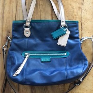 Blue coach bag, hand and shoulder strap.
